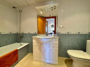 a bathroom with a sink and a tub and a toilet at Brisa del Delta & Pool in L'Eucaliptus +17 photos