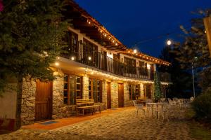 a building with tables and chairs outside at night at Hotel La Casona Real in Huasca de Ocampo +20 photos