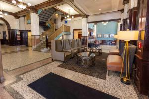 a lobby with a waiting room with chairs and a table at Drury Plaza Hotel St Louis Union Station in Saint Louis