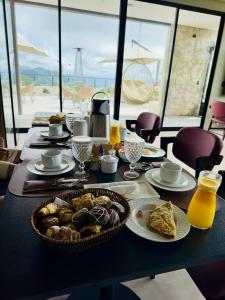a table with a plate of food on it at Villa Real Chalés in Viçosa do Ceará