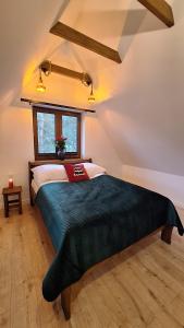 a bedroom with a large bed in a attic at Domek Julia in Krościenko