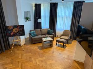 a living room with a couch and a chair at VillaWie in Rheda-Wiedenbrück