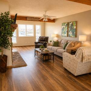 a living room with a couch and a table at The Calm Cove - Near shopping and entertainment in Osage Beach