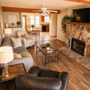 a living room with a couch and a fireplace at The Calm Cove - Near shopping and entertainment in Osage Beach