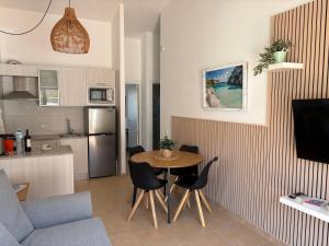 a small kitchen with a table and chairs in a room at Garbí & Xaloc apartamentos in Cala Galdana