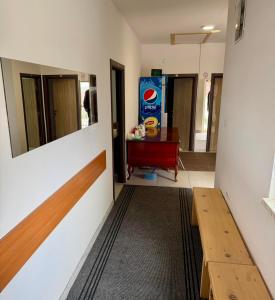 a hallway with a bench and a table in a room at Apartmani Herceg in Gacko