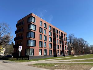 a red brick building on the side of a street at Nameja Apartamenti in Riga