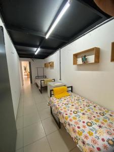a bedroom with a bed with a yellow pillow on it at quintal293 in Recife