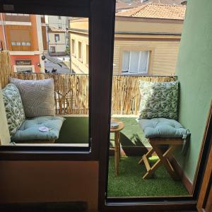 a view of a balcony with two chairs and a table at Espacio Yina Grado in Grado