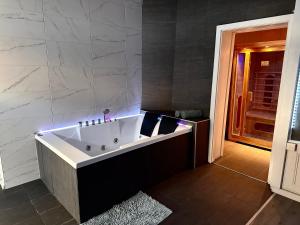 a bathroom with a bath tub in a room at La suite 44 in Le Locle