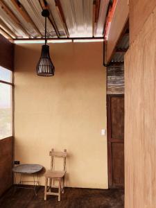 a room with a chair and a table and a door at Los Asentamientos in Máncora +61 photos