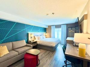 a hotel room with a bed and a couch at Comfort Suites in London