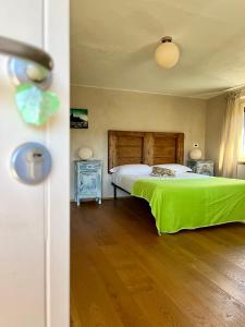 a bedroom with a bed and a wooden floor at La Mela Antica in Cherasco