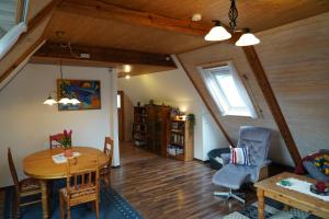 a living room with a wooden table and a dining room at Nordseerex in Ahrenshöft