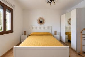 a bedroom with a large bed with a yellow bedspread at Chez Fifi in Surpierre +7 photos