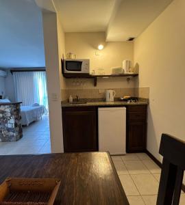 a small kitchen with a table and a microwave at Villa Ostende Apart Hotel & Spa in Ostende