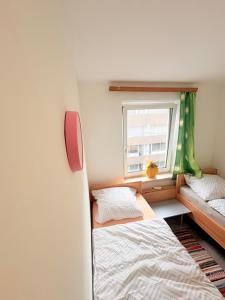 a small bedroom with a bed and a window at Beenie 3 in Linz