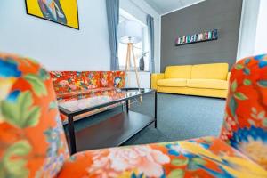 a living room with two couches and a coffee table at Wirtshaus Feininger Hof in Benz