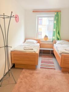a bedroom with two beds and a window at Beenie 3 in Linz