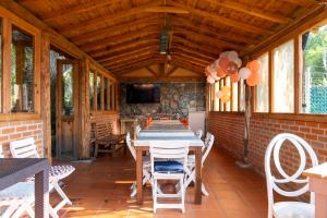 a dining room with a table and chairs on a patio at Hotel La Casona Real in Huasca de Ocampo