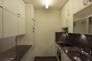 a kitchen with a sink and a counter top at Appartement im Park in Minusio