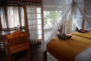 
A bed or beds in a room at Raja Ampat Dive Resort
