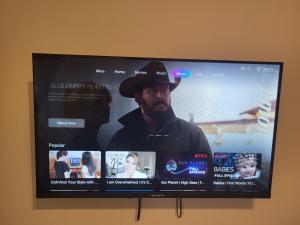 a flat screen tv with a man in a hat at Apartment K2 in Pyrgi