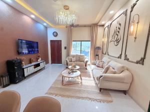 a living room with couches and a chandelier at AG ViLLA NERAL in Neral