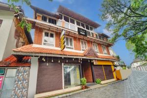 a building with a sign on the front of it at Collection O Calvathy Road Near Fort Kochi in Cochin