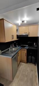 a kitchen with wooden cabinets and a sink at Le Désiré in Arras