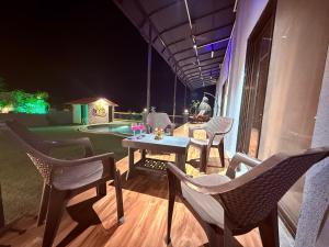 a patio with chairs and a table at night at AG ViLLA NERAL in Neral