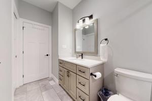 a white bathroom with a sink and a mirror at Prettiest town's lake- Bungalow in Goderich +43 photos