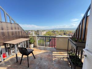 a balcony with a table and chair on a building at Airport Hotel Apartments in Tbilisi City