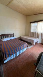a bedroom with two beds and a window at Accommodation in Copán Ruinas #7 in Copán Ruinas
