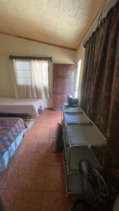 a room with a bedroom with a bed and a desk at Accommodation in Copán Ruinas #7 in Copán Ruinas