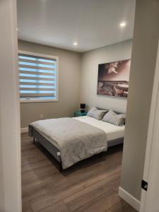 a bedroom with a large bed and a window at Prettiest town's lake- Bungalow in Goderich