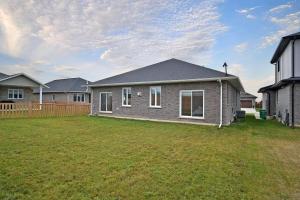 a house with a yard in front of a house at Prettiest town's lake- Bungalow in Goderich