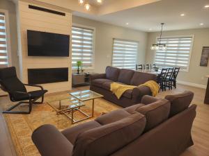 a living room with a couch and a flat screen tv at Prettiest town's lake- Bungalow in Goderich