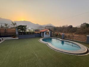 a swimming pool on a lawn with a gazebo at AG ViLLA NERAL in Neral