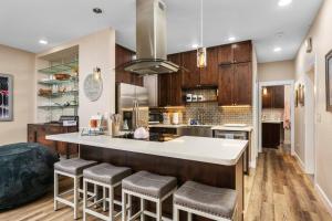 a kitchen with a large island with bar stools at Peaks View Bunk House in Hillsboro