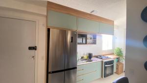 a kitchen with a stainless steel refrigerator at Aconchego Perto das praias da região oceânica in Niterói