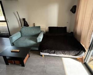 a living room with a couch and a bed at Grand Studio AFA in Afa