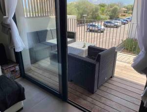 a screened in porch with a view of a parking lot at Grand Studio AFA in Afa