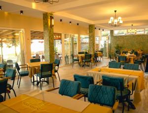 a dining room with tables and chairs and tablesktop at Villa Strmec in Peštani