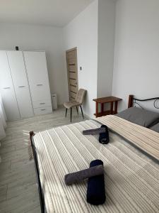 a bedroom with a bed with a pair of slippers on it at Vecpilsētas apartaments in Cēsis