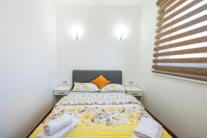 a bedroom with a bed with towels on it at Apartmani Dino Kolasin in Kolašin