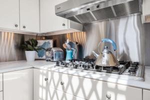 a kitchen with a stove with a tea kettle on it at Salty Sunrise in Aptos