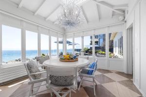 a dining room with a table and chairs and the ocean at Salty Sunrise in Aptos +33 photos