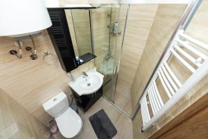 a bathroom with a white toilet and a sink at Apartmani Dino Kolasin in Kolašin +30 photos