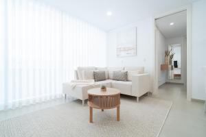 a living room with a white couch and a table at Nina da Nazare in Nazaré
